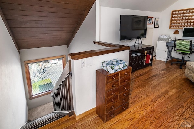 interior space featuring wooden ceiling, baseboards, vaulted ceiling, and wood finished floors