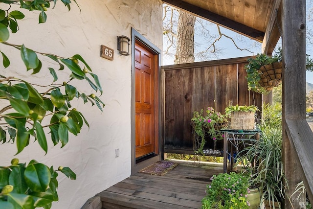 view of exterior entry featuring fence