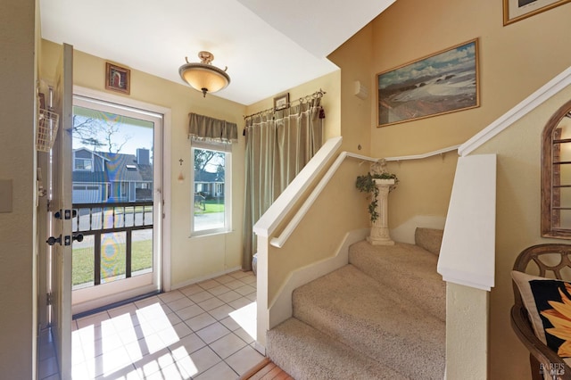 entryway featuring stairs and tile patterned flooring