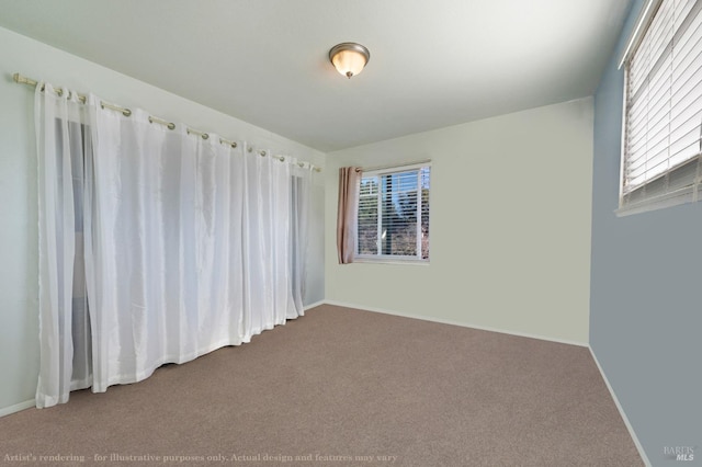 empty room featuring carpet flooring and baseboards