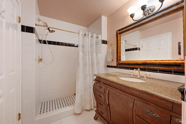 bathroom with a stall shower, tile patterned floors, and vanity