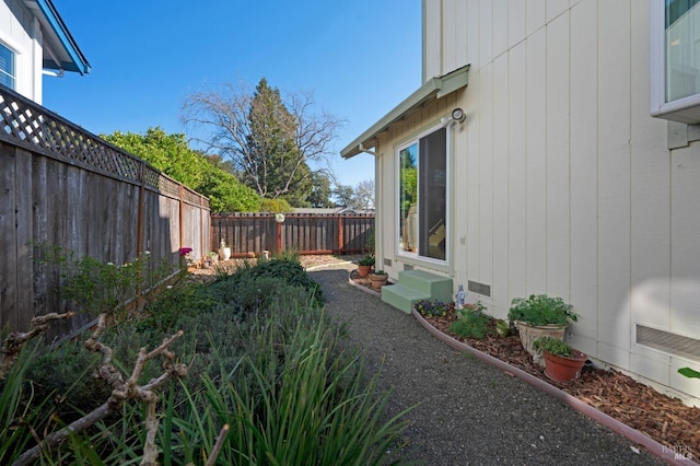 view of yard with entry steps and a fenced backyard