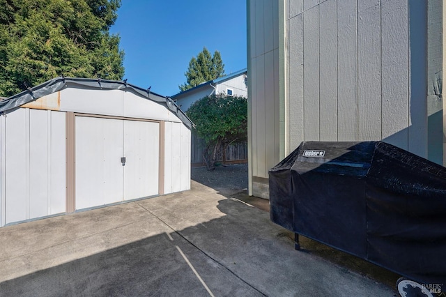 view of shed featuring fence