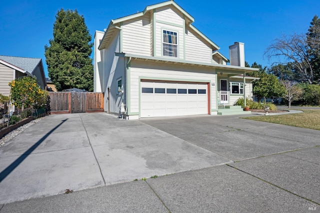 view of side of home featuring a garage, concrete driveway, a chimney, and fence