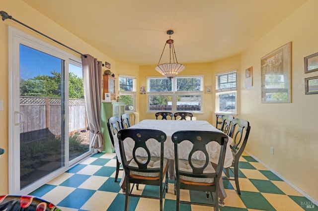 dining area featuring tile patterned floors and baseboards