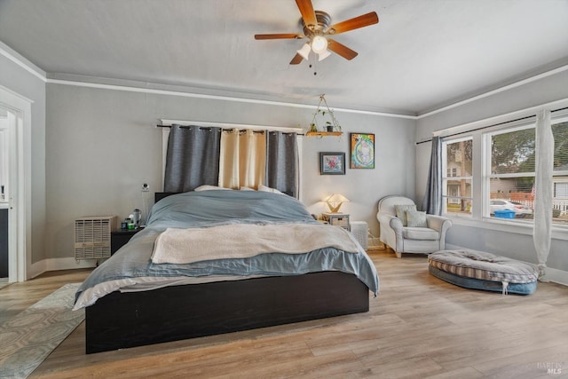 bedroom with crown molding, ceiling fan, and light wood-type flooring