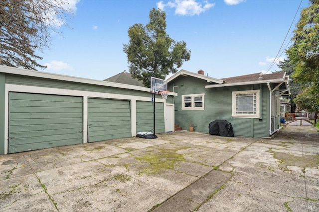 rear view of property featuring a garage