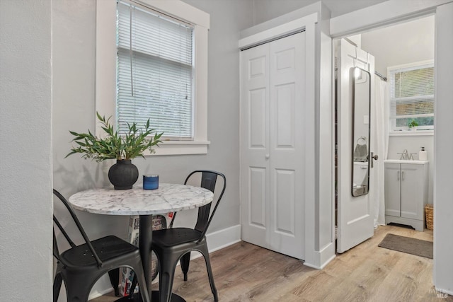 dining area featuring sink and light hardwood / wood-style floors