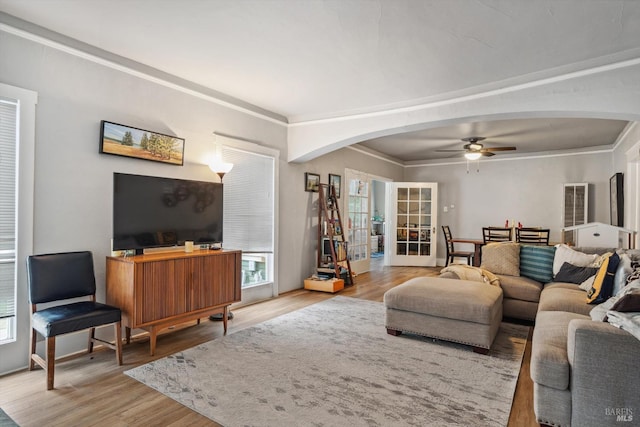 living room with crown molding, ceiling fan, plenty of natural light, and hardwood / wood-style floors