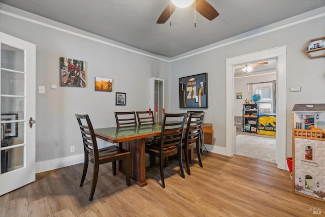 dining space with hardwood / wood-style flooring and ceiling fan