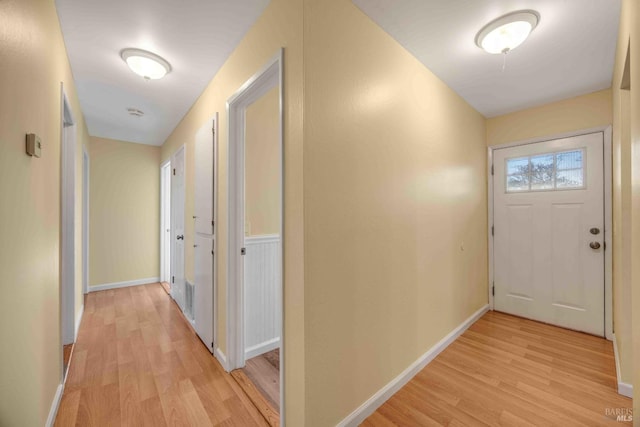 hallway with light hardwood / wood-style flooring