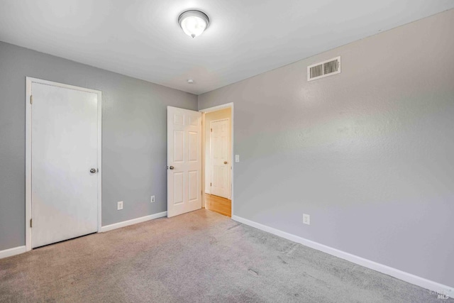 unfurnished bedroom with light colored carpet