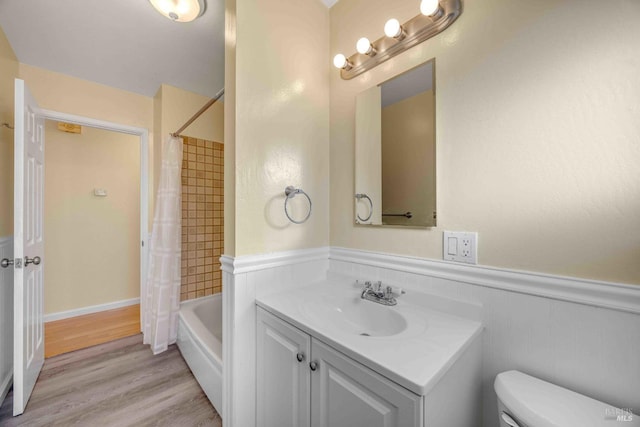 full bathroom with vanity, toilet, hardwood / wood-style floors, and shower / bath combo with shower curtain