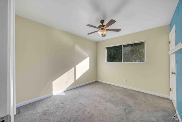 unfurnished room featuring light colored carpet and ceiling fan