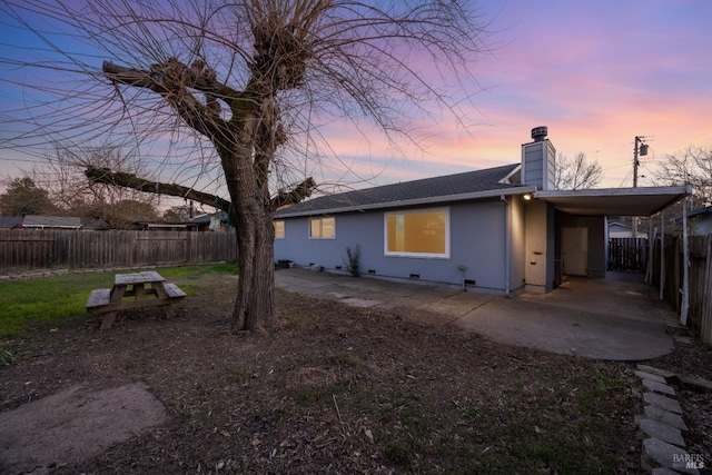 view of back house at dusk