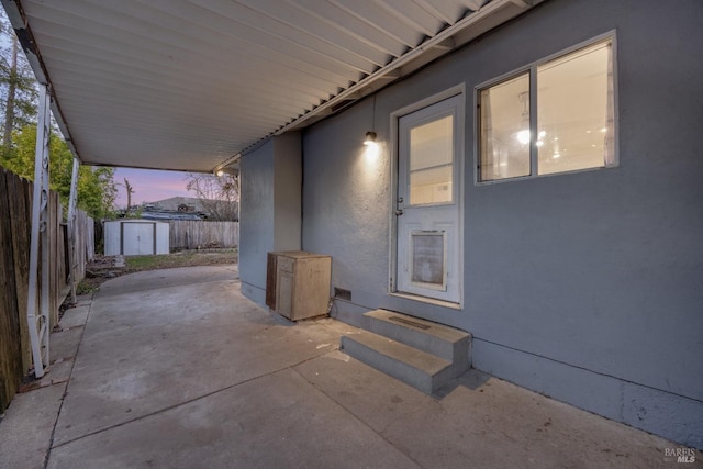 patio terrace at dusk with a storage shed