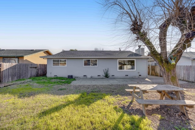 rear view of property with a patio and a yard