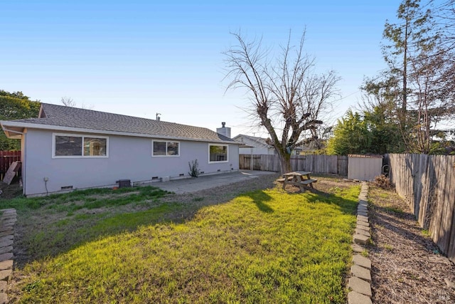 back of house with a lawn