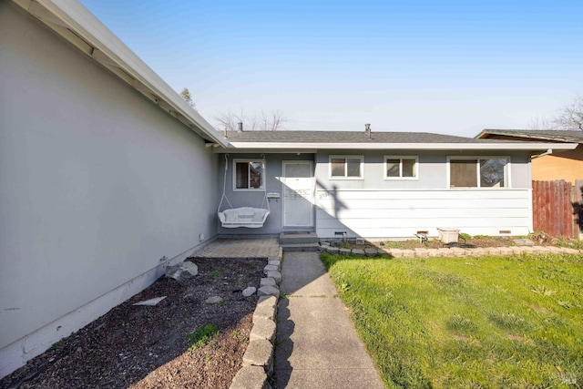 entrance to property featuring a yard