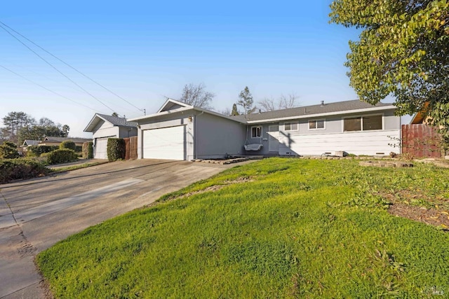 ranch-style home featuring a garage and a front yard