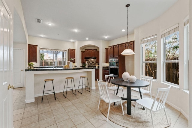 dining area featuring light tile patterned floors, baseboards, visible vents, and recessed lighting