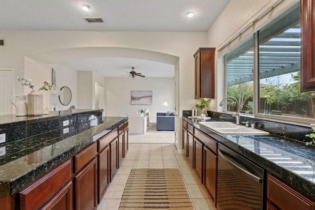 kitchen with visible vents, arched walkways, dishwasher, a sink, and light tile patterned flooring