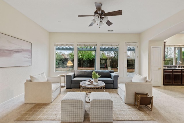 interior space with visible vents, ceiling fan, a sink, and a wealth of natural light