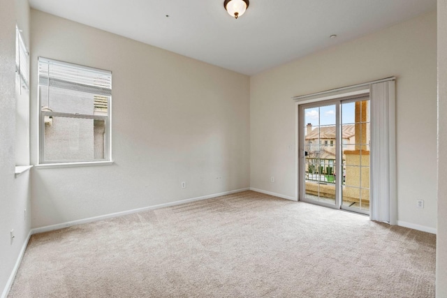 empty room with carpet floors and baseboards