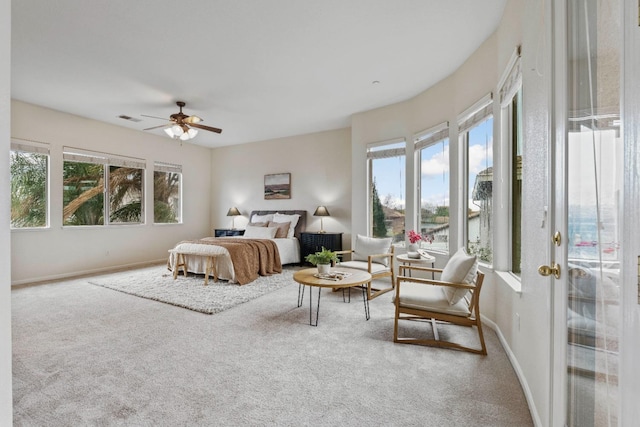 carpeted bedroom featuring visible vents, ceiling fan, baseboards, and multiple windows