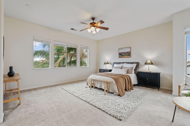 carpeted bedroom featuring visible vents, ceiling fan, and baseboards