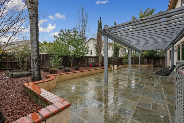 view of patio / terrace featuring a fenced backyard and a pergola