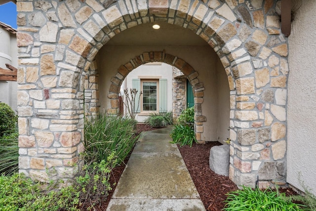 entrance to property featuring stone siding