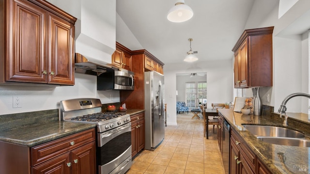 kitchen featuring light tile patterned floors, appliances with stainless steel finishes, a ceiling fan, a sink, and baseboards