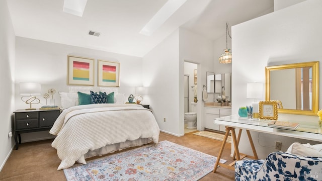 bedroom with lofted ceiling with skylight, light colored carpet, and baseboards