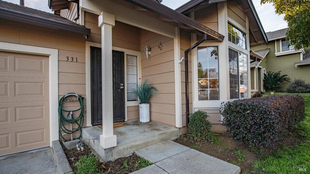 view of exterior entry with a garage