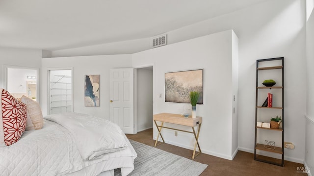 bedroom with carpet, visible vents, connected bathroom, and baseboards