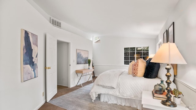 bedroom with lofted ceiling and visible vents