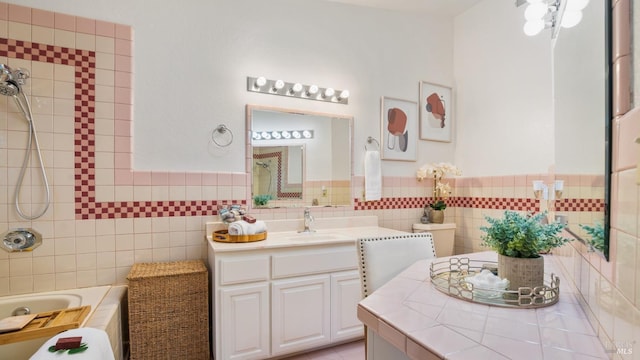 full bathroom featuring wainscoting, vanity, and tile walls