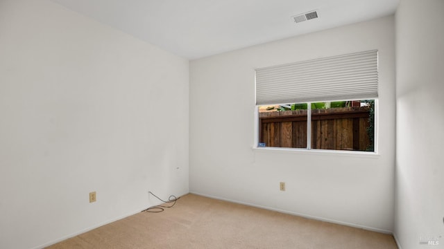 unfurnished room with visible vents and carpet flooring