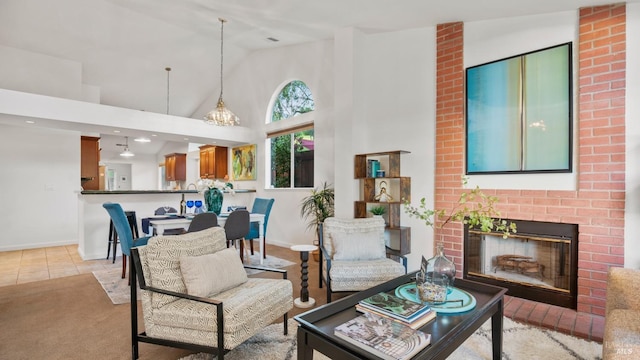 living room with high vaulted ceiling, a brick fireplace, light tile patterned flooring, and baseboards