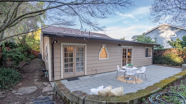 rear view of property featuring a patio and fence