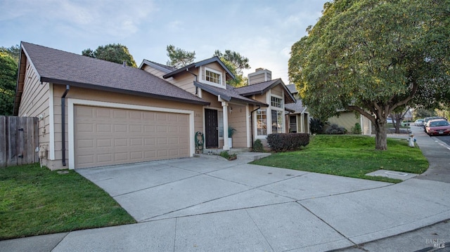 view of front of house with a chimney, concrete driveway, an attached garage, fence, and a front lawn