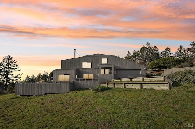 property exterior at dusk featuring a yard and an outbuilding