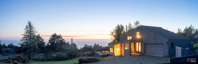 exterior space featuring gravel driveway and a garage