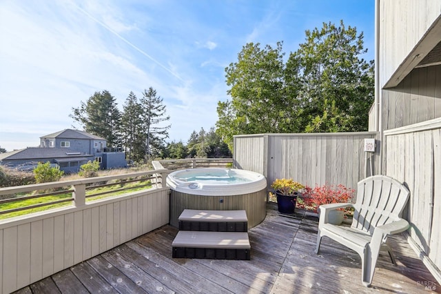 wooden deck with fence and a hot tub