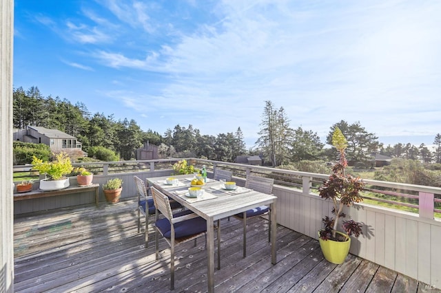 wooden terrace featuring outdoor dining area