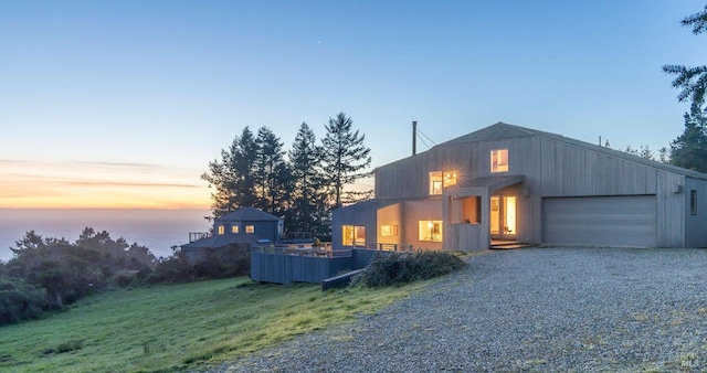 contemporary house featuring driveway, a front yard, and a garage