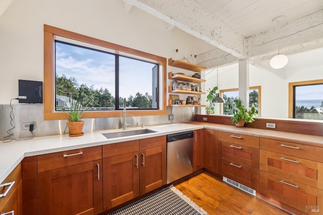 kitchen featuring visible vents, light wood finished floors, a sink, light countertops, and stainless steel dishwasher