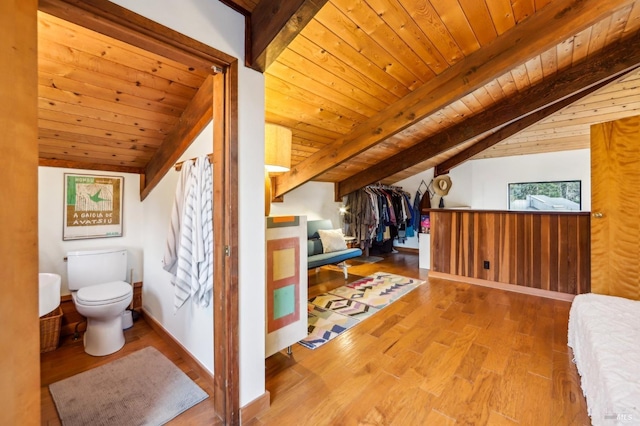 interior space with wooden ceiling, vaulted ceiling with beams, baseboards, and wood finished floors