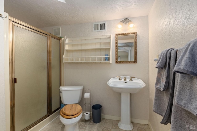 825 N Forbes St, Lakeport, CA 95453 - bathroom featuring an enclosed shower, sink, toilet, and a textured ceiling